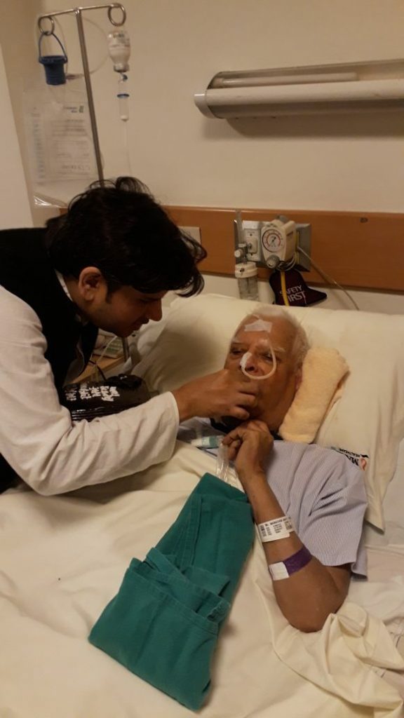 Son Rohit Shekhar feeding ND Tiwari at a hospital.