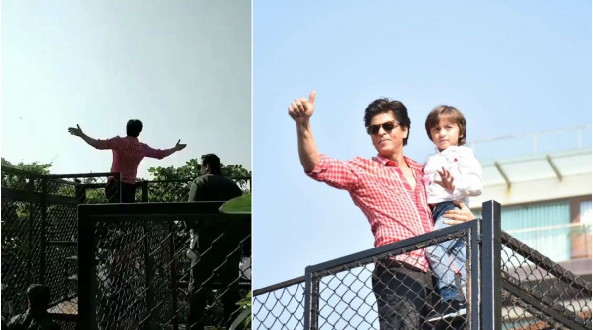 Shah Rukh Khan strikes his signature pose as he greets fans outside Mannat