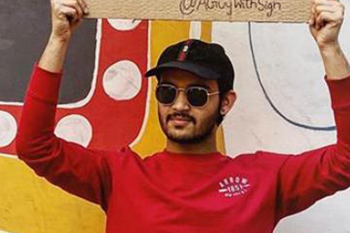 Indian Guy delivers pertinent messages to society and people by simply holding placards